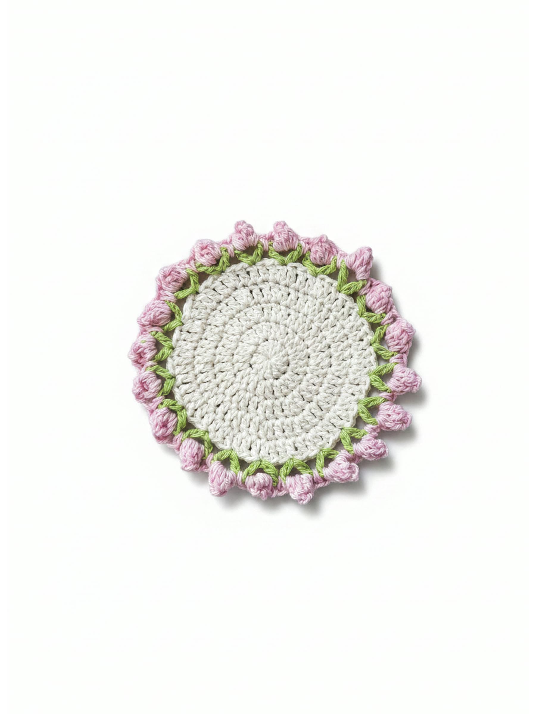 Crochet rosebud coaster on a plain white studio background